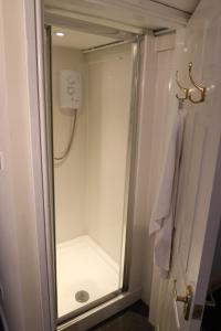 a bathroom with a shower with a glass door at BroomfieldBarns1A in Swettenham +9 photos