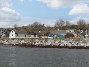 a group of houses on the shore of a river at Sunrise Summerhouse in Hilton of Cadboll