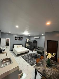 a large room with a bed and a living room at Balai Magayon Hometel in Aplaya