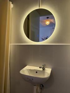 a bathroom with a sink and a mirror at La Casa Del Comienzo- Plumera Mactan Near Airport in Lapu Lapu City