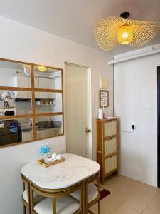 a dining room with a table and a light at La Casa Del Comienzo- Plumera Mactan Near Airport in Lapu Lapu City