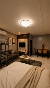 a bedroom with a bed and a living room at Balai Magayon Hometel in Aplaya