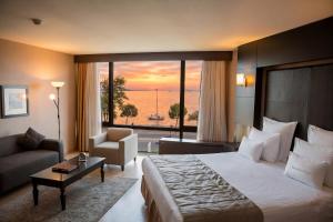 a hotel room with a bed and a large window at Kalyon Hotel Istanbul in Istanbul