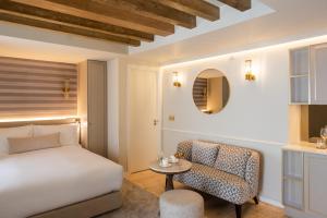 a bedroom with a bed and a chair and a table at Villa Dorothea in Lisbon +77 photos