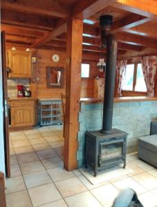 a living room with a stove in a cabin at Chalet Indépendant " L'anfian-ne" in Les Contamines-Montjoie