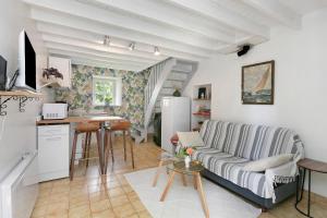 a living room with a couch and a table at Gîte La P'tite Longère in Saint-Jacut-les-Pins
