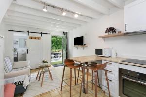 a kitchen with a table and chairs in a room at Gîte La P'tite Longère in Saint-Jacut-les-Pins +14 photos