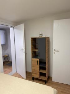 a bedroom with a bed and a wooden cabinet at Dorotea Apartment in Ohrid +20 photos