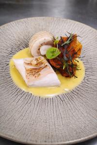 a plate of food with meat and vegetables on it at Auberge de la Loire in Montjean-sur-Loire +27 photos