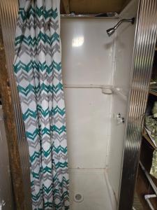 a refrigerator with a shower curtain in a room at The Whip-o-Will in Moss Point