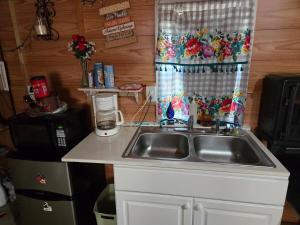 a kitchen counter with a sink and a window at The Whip-o-Will in Moss Point