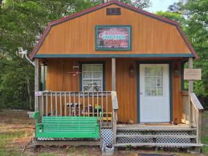 a small house with a bench in front of it at The Whip-o-Will in Moss Point