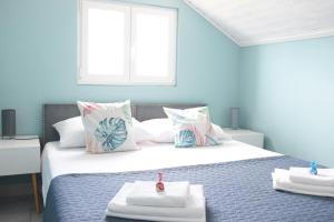 a bedroom with a bed with two towels on it at Villa Luger 2 Dachgeschoss in Rogoznica +33 photos
