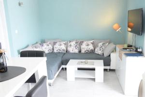a living room with a couch and a table at Villa Luger 2 Dachgeschoss in Rogoznica