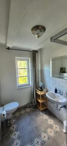a bathroom with a tub and a sink and a window at Denkmal Haus Hugo in Medebach +49 photos