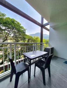 a table and chairs on a balcony with a view at Tropical Escape at Pico De Loro in Nasugbu +34 photos