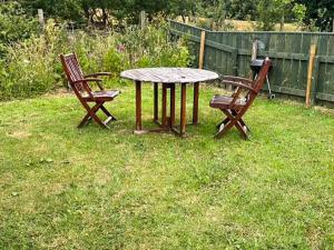 two chairs and a table in a yard at Woodpecker Hollow - Uk45980 in Ebchester +4 photos