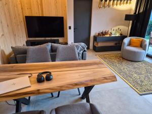 a living room with a couch and a tv at Kabata 2620 ` Кабата 2620 in Bansko