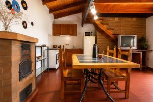 a kitchen with a wooden table and chairs in it at Tala in Villa Cura Brochero