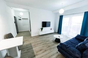 a living room with a couch and a tv at VISAJ Nova in Timişoara