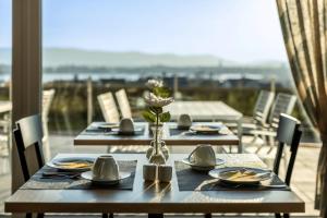 a table with plates of food and a vase with flowers at Hotel Kapelle in Radolfzell am Bodensee