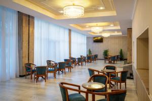 a dining room with tables and chairs in a room at Hotel Belvedere in Cluj-Napoca