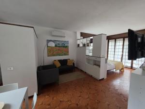 a living room with a couch and a tv at Maison Leti Comfort Studio in Bellagio