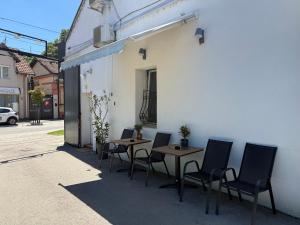 a group of tables and chairs next to a building at THE ONLY ONE Accommodation in Niš