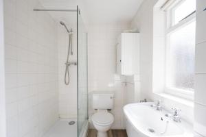 a bathroom with a toilet and a sink and a bath tub at Stuckie Ben, Southwold in Southwold +21 photos