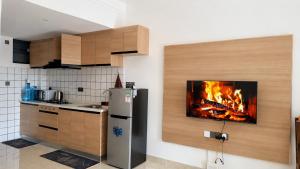 a kitchen with a fire in the wall at Casa Liora Studio by UN & Two Rivers in Nairobi