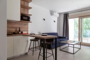 a kitchen with a table and a blue chair at Studio Rimini 523, Kotor in Kotor