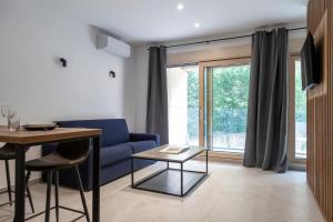 a living room with a blue couch and a table at Studio Rimini 523, Kotor in Kotor +18 photos