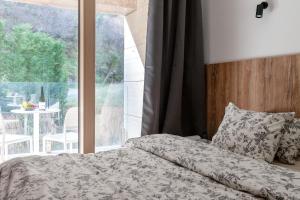 a bedroom with a bed and a large window at Studio Rimini 523, Kotor in Kotor