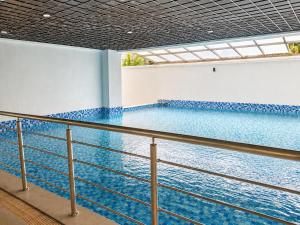 a large swimming pool in a building with a ceiling at Casa Liora Studio by UN & Two Rivers in Nairobi