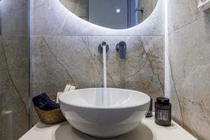 a bathroom with a bowl sink and a mirror at Kastri Houses in Panormos Skopelos +22 photos