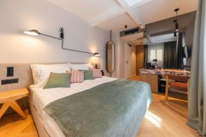a bedroom with a large bed and a bathroom at Hidden Tree Heritage Hotel in Zadar