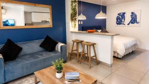 a living room with a couch and a kitchen with a bed at Luxury Coastal Escape Coral Point Sibaya Pool & WiFi in Durban +60 photos