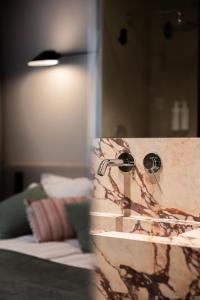 a bathroom with a sink and a mirror at Hidden Tree Heritage Hotel in Zadar +38 photos