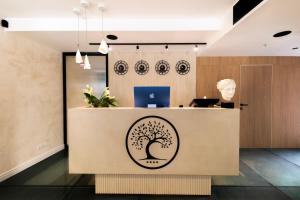 an office with a tree logo on the reception desk at Hidden Tree Heritage Hotel in Zadar