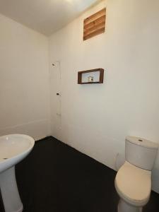 a bathroom with a toilet and a sink at Arugam Bay Beach House in Pottuvil
