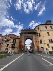 an archway in the middle of a street with buildings at Borgo Vallelunga house Campagnano Di Roma in Campagnano di Roma