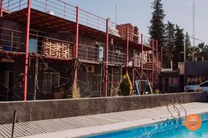 a building under construction next to a swimming pool at Hotel Nora in Calingasta +2 photos