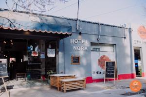 a hotel noaa building with a bench in front of it at Hotel Nora in Calingasta
