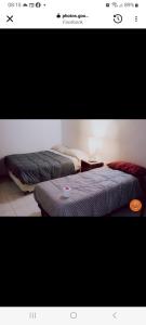 two beds sitting next to each other in a room at Hotel Nora in Calingasta