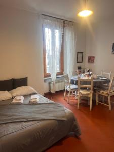 a bedroom with a bed and a table with chairs at Borgo Vallelunga house Campagnano Di Roma in Campagnano di Roma