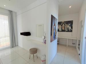 a white room with a chair and a picture on the wall at Villa Luxury Paradise Suites in Salobreña