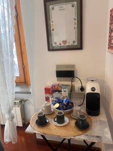a table with cups and a plate of food on it at Borgo Vallelunga house Campagnano Di Roma in Campagnano di Roma