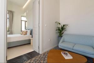 a living room with a bed and a couch and a table at Gioma Luxury Villas in Agios Nikolaos +23 photos