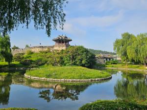 an island in the middle of a river with a castle at 행궁동-House2 in Suwon