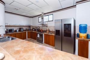 a large kitchen with wooden cabinets and stainless steel appliances at Galapagos Family Vacation 3 bedrooms 7 guests Centrally located and ocean view in Puerto Ayora